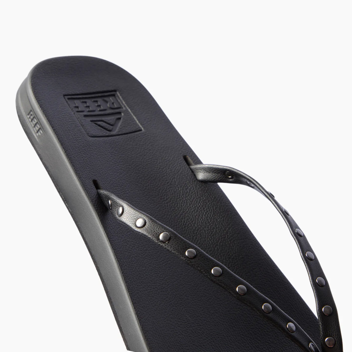Cushion Slim Studs black women's sandal facing left, close-up of straps with slim studs, comfort-focused beach footwear.
