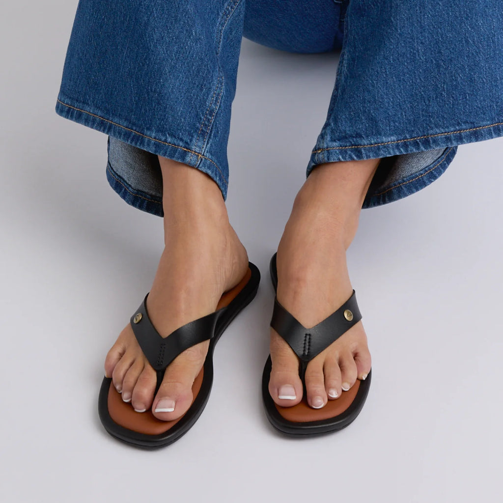 Willow Ella black sandals shown from above on feet, featuring comfort cushioning and anatomical arch support