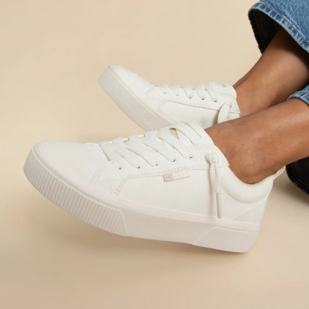 Lay Day Dawn women's white sneakers facing right, close-up on shoe upper and sole, beach-inspired comfort design.
