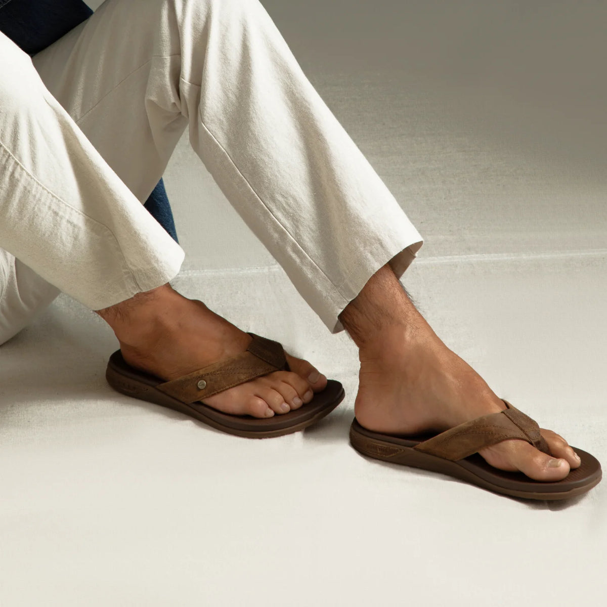 Phantom Lux men’s brown flip flops facing right, close-up of top and side showing cushioned, water-friendly design.