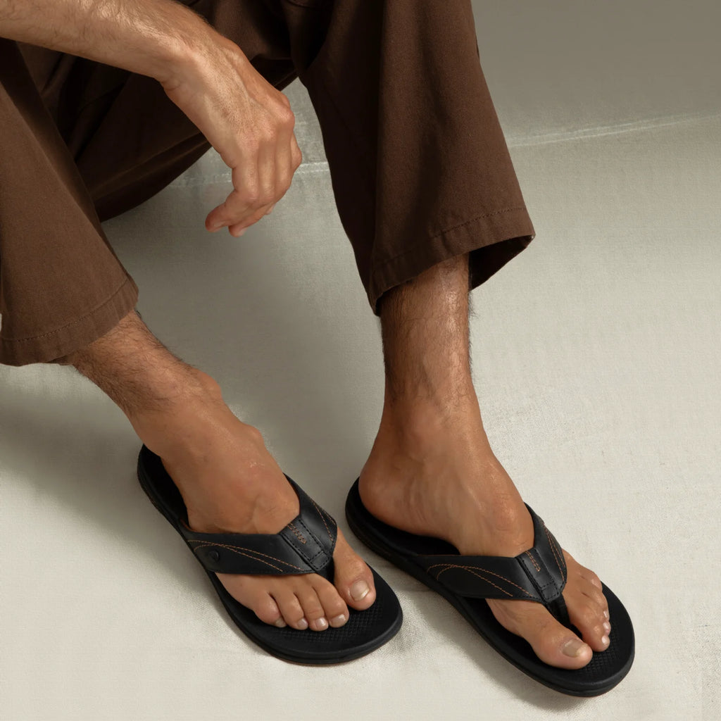 Phantom Lux men's black flip flops facing forward, showing top with extra cushioning and arch support features.