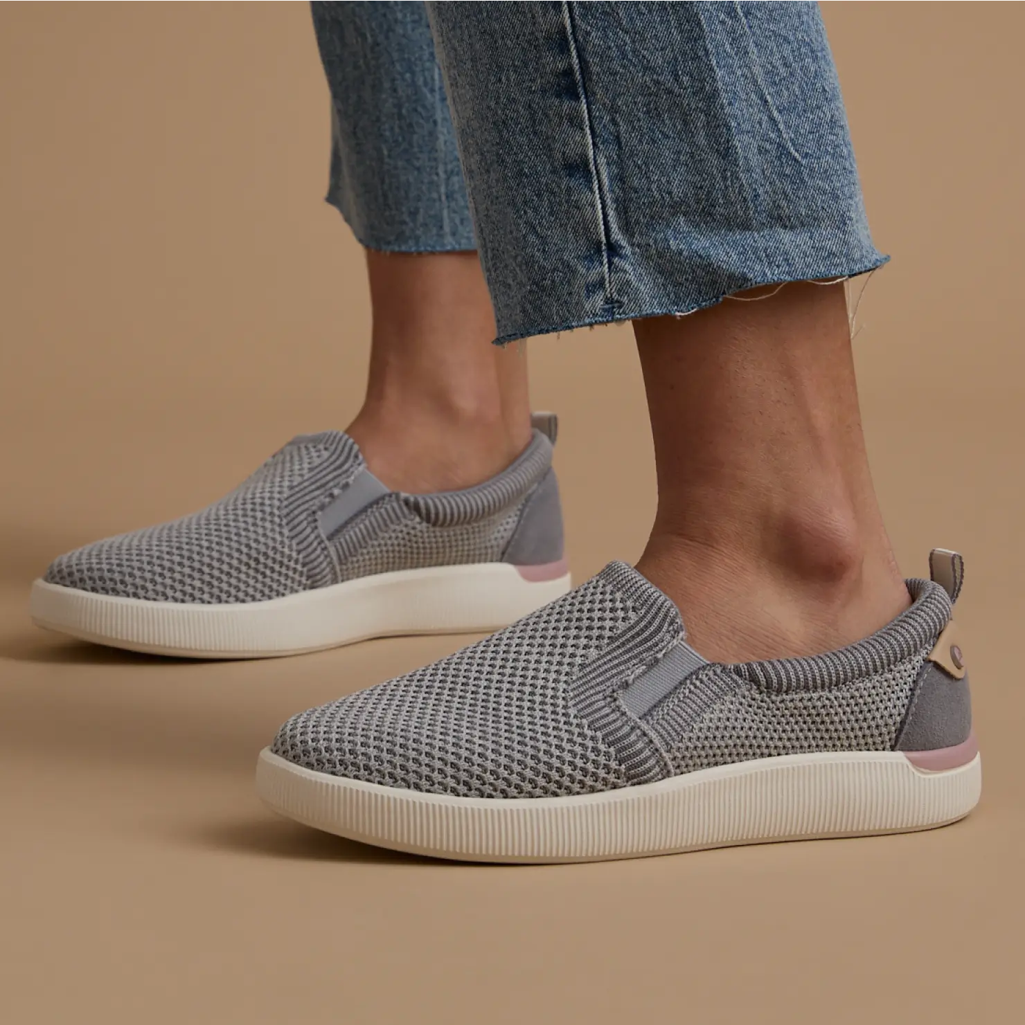 Neptune Elyse grey slip-on shoes facing right, showing side and top, with breathable mesh and cushioned sole for comfort.