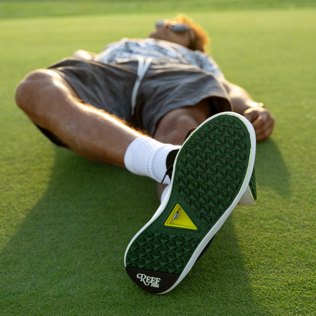 Onshore Pines men's sneaker sole facing camera showing durable, water-friendly sole with arch support on grass