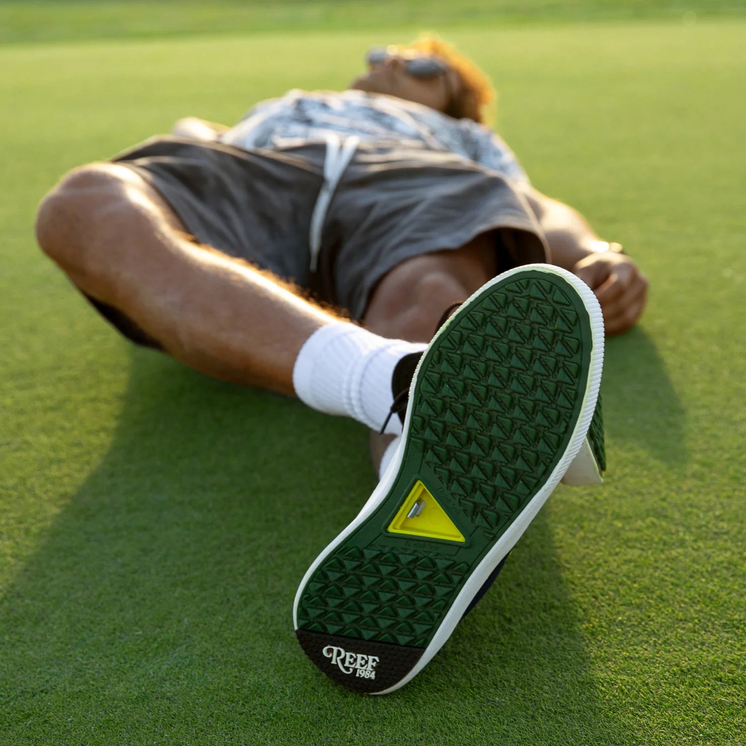 Onshore Pines men's sneaker sole facing camera showing durable, water-friendly sole with arch support on grass