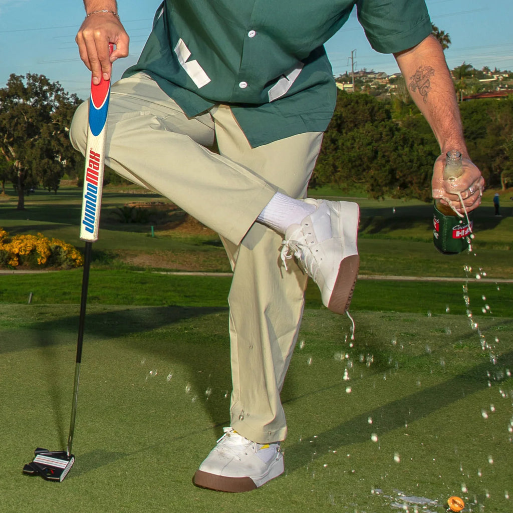 Onshore Pines white gum sneaker facing left mid-action with water splashing, showing durable, comfortable design