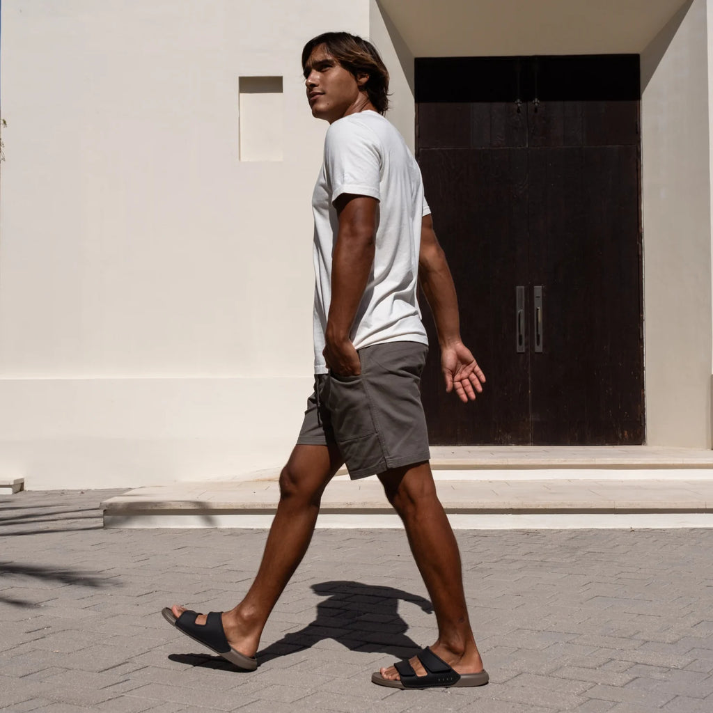 Man walking right wearing Oasis Adapt sandals facing right, showing side view with comfort and arch support design