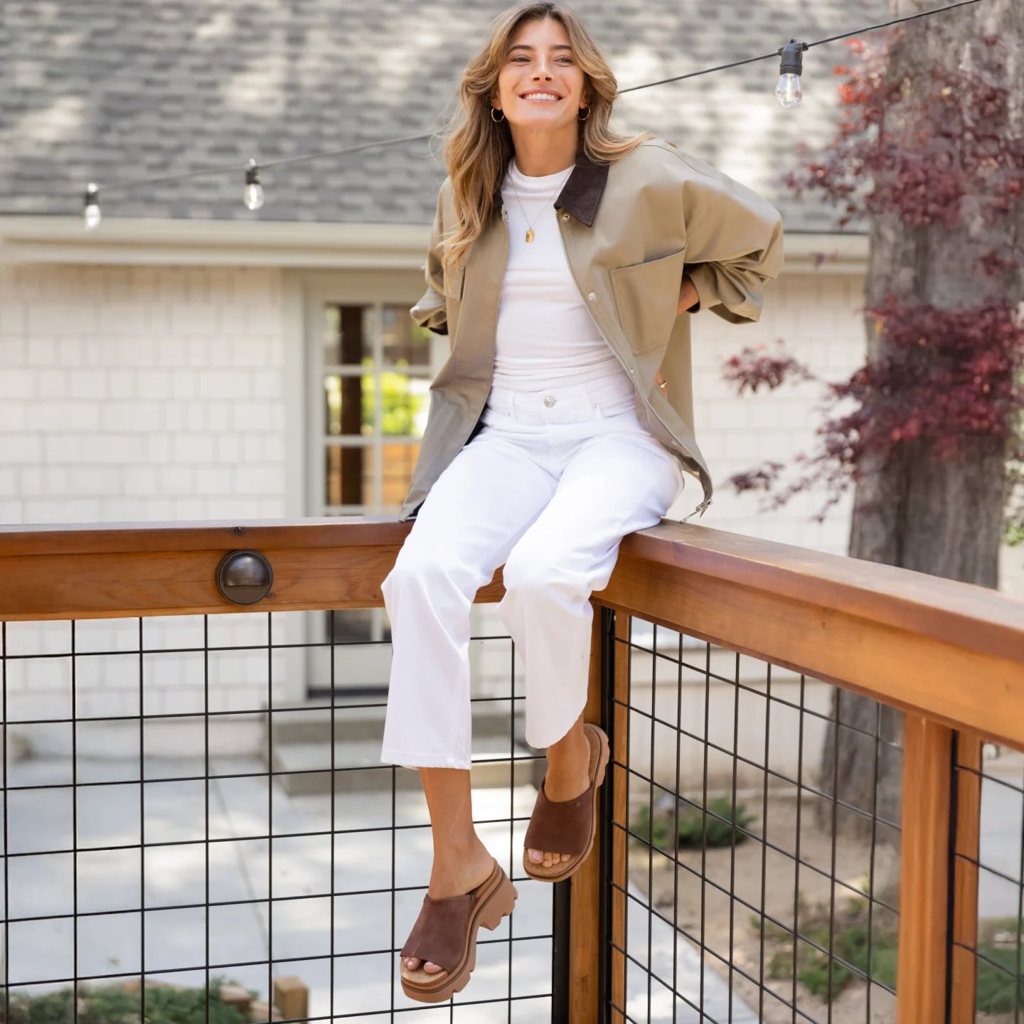 Woman wearing brown Vista Luxe Evie sandals facing left, showing side view with soft cushioning and arch support.