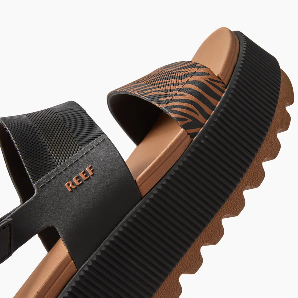 Close-up of the left side of the Water Vista Higher sandal showing black and brown textured straps with arch support and ridged sole