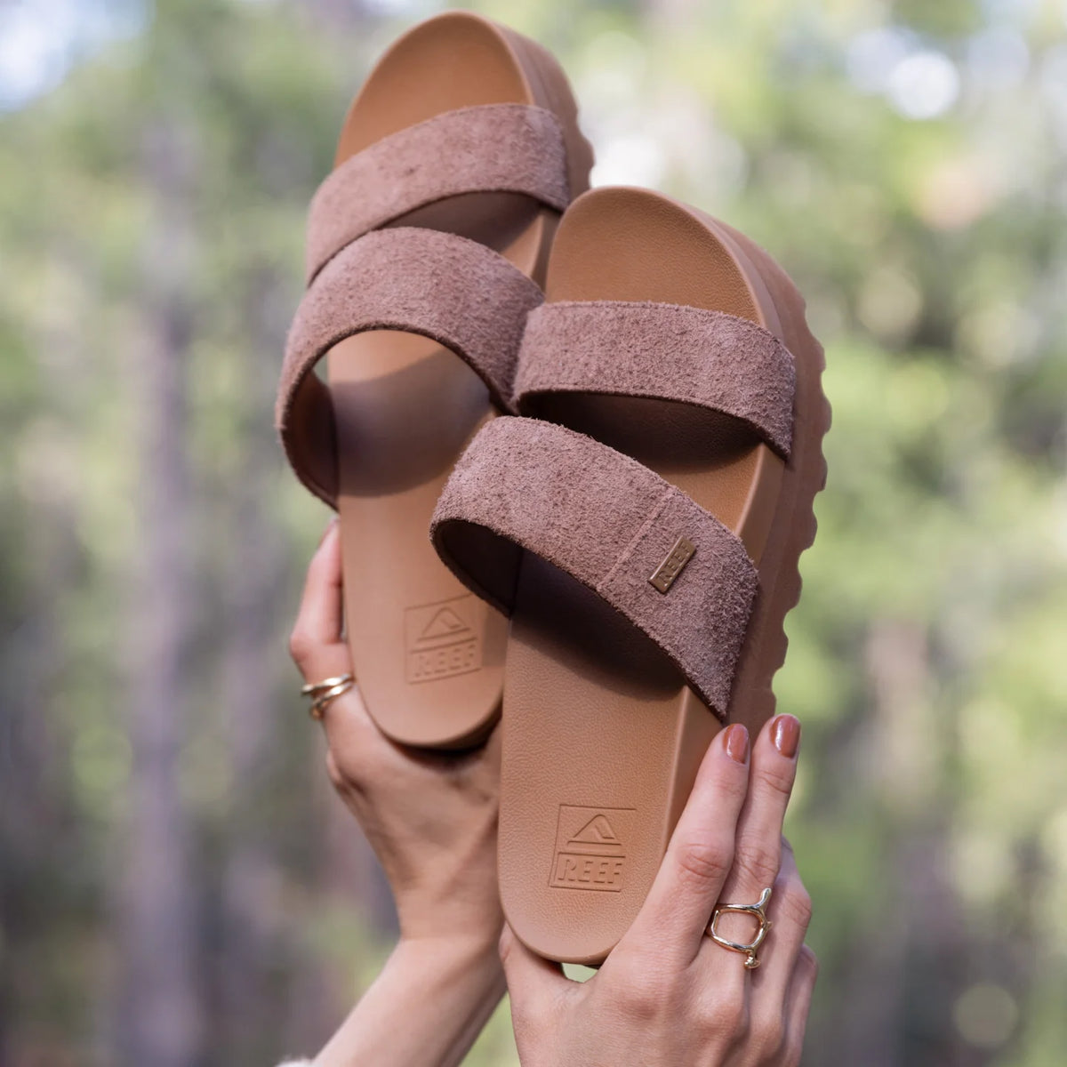 Pair of Cushion Vista Hi sandals facing forward held by hands, featuring soft-rebound cushioning and anatomical arch support
