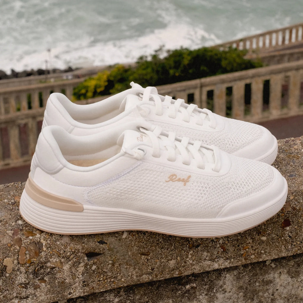 Pair of white Shoreline Palisades sneakers facing right, showing knit upper and cushioned sole for beach comfort.