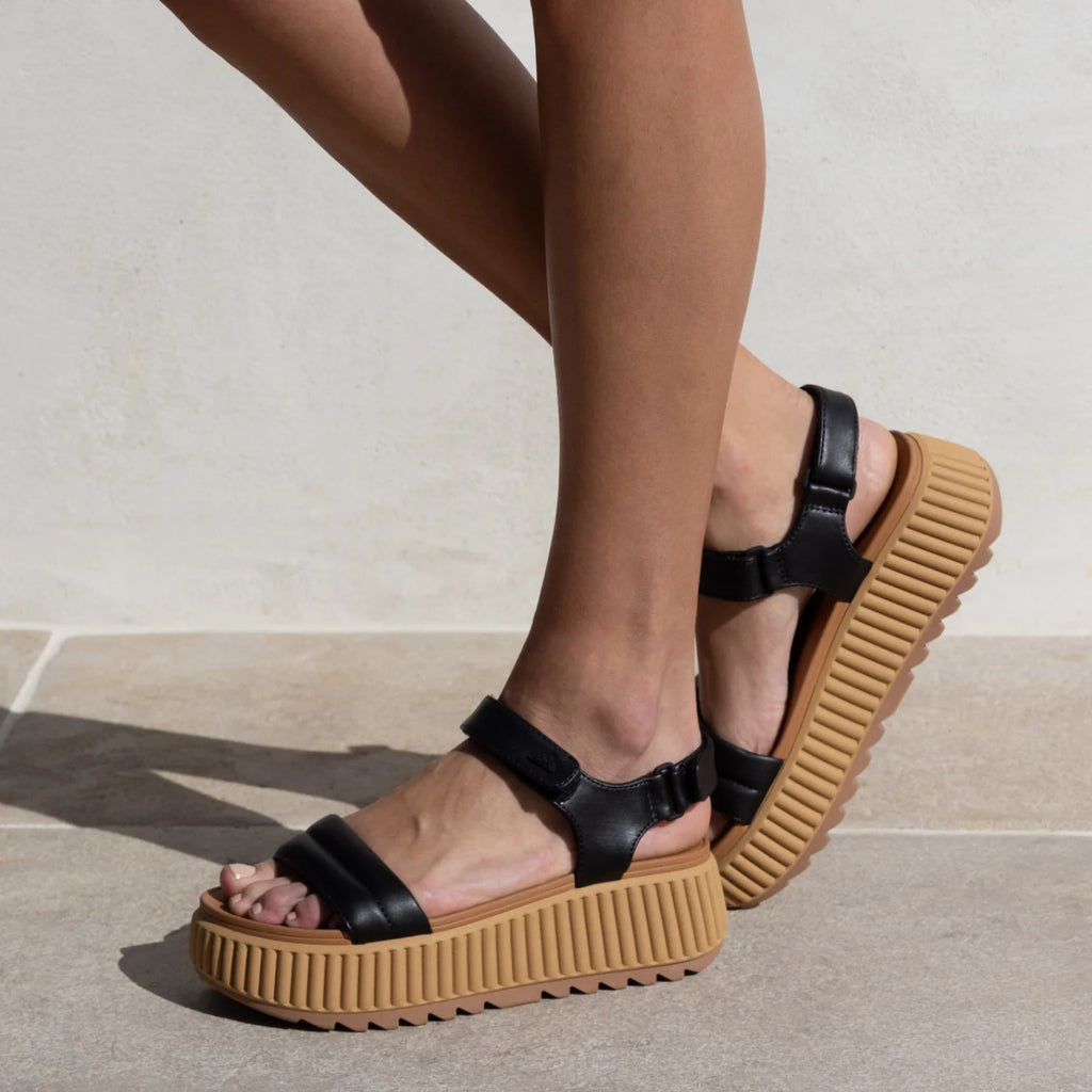 Vista Higher Raya women's black sandals facing left, close-up of side view, with cushioned platform sole and arch support.