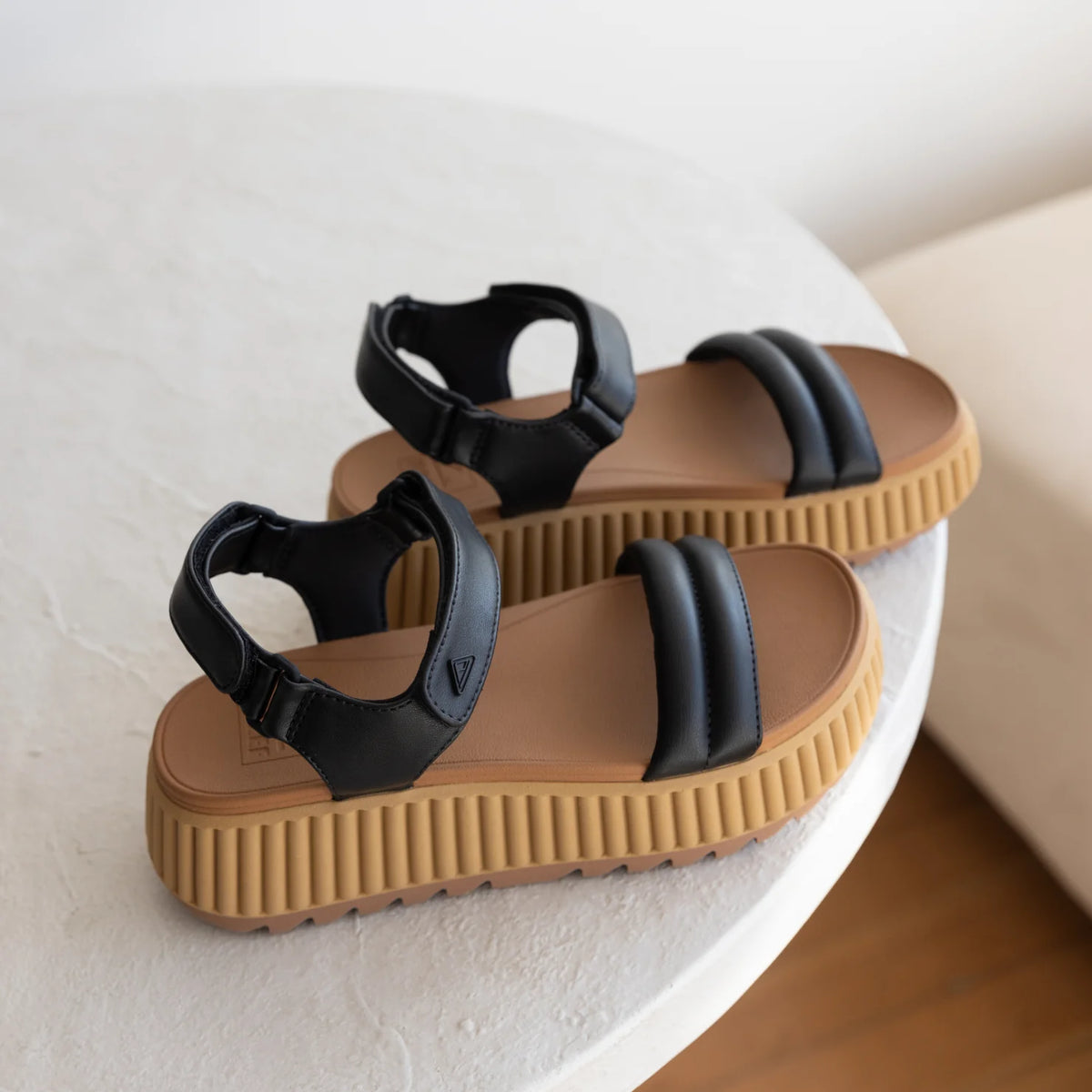 Vista Higher Raya women's black sandals facing left, close-up of cushioned straps and ribbed platform sole for comfort.