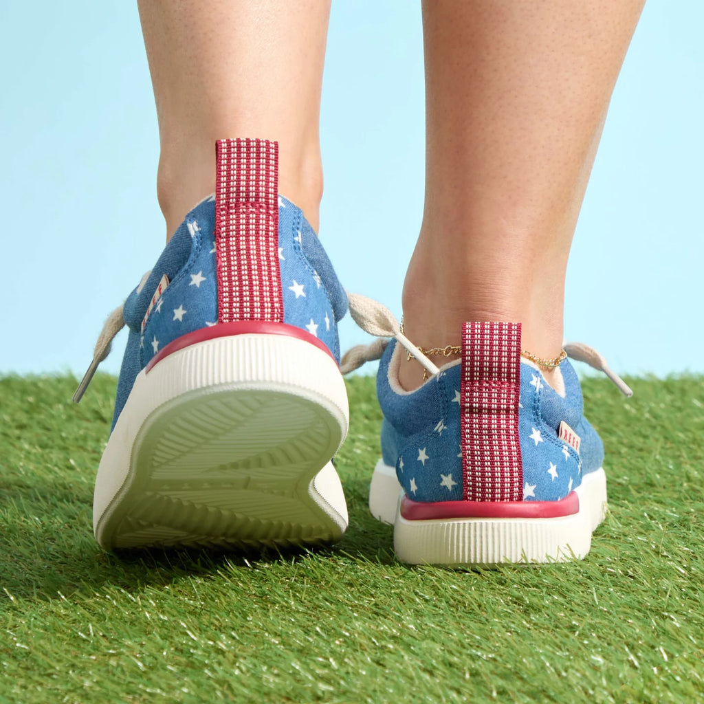 Pair of Neptune Alana sneakers facing backward, showing heel and red pull tab, surf-inspired comfort and durable design.