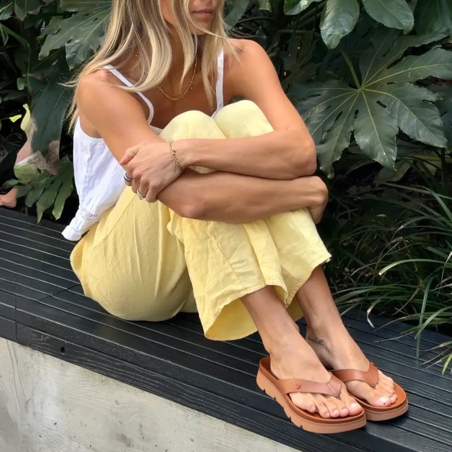 Vista Luxe Vivianahh sandals facing forward, close-up of tan water-friendly flip flops with arch support on woman’s feet
