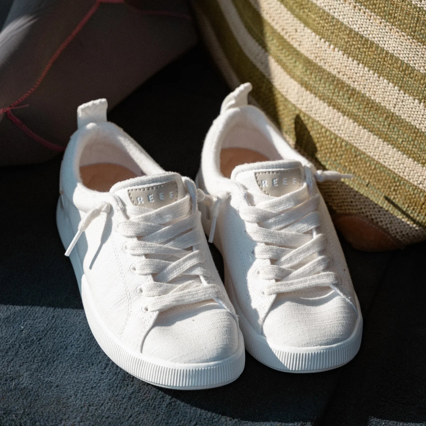 Pair of white Neptune Alana sneakers facing forward showing front and top with surf-inspired comfort and support features.