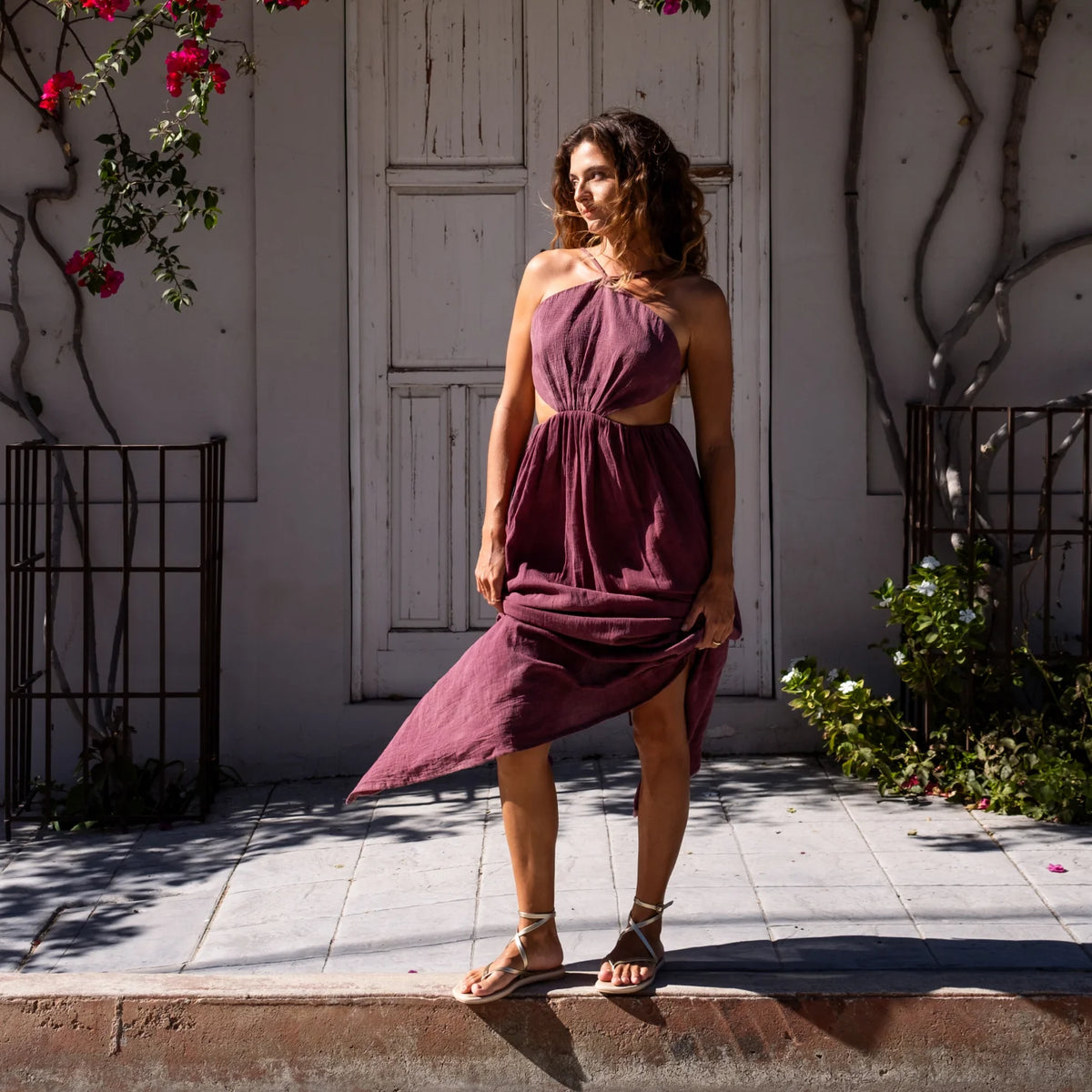Willow Quinn sandals facing forward on woman standing in a purple dress outdoors, highlighting comfort and beach-inspired style.