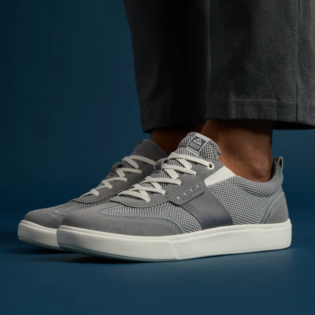 Triton men's grey sneaker facing left, showing side and top with soft cushioning and arch support, beach-inspired comfort.