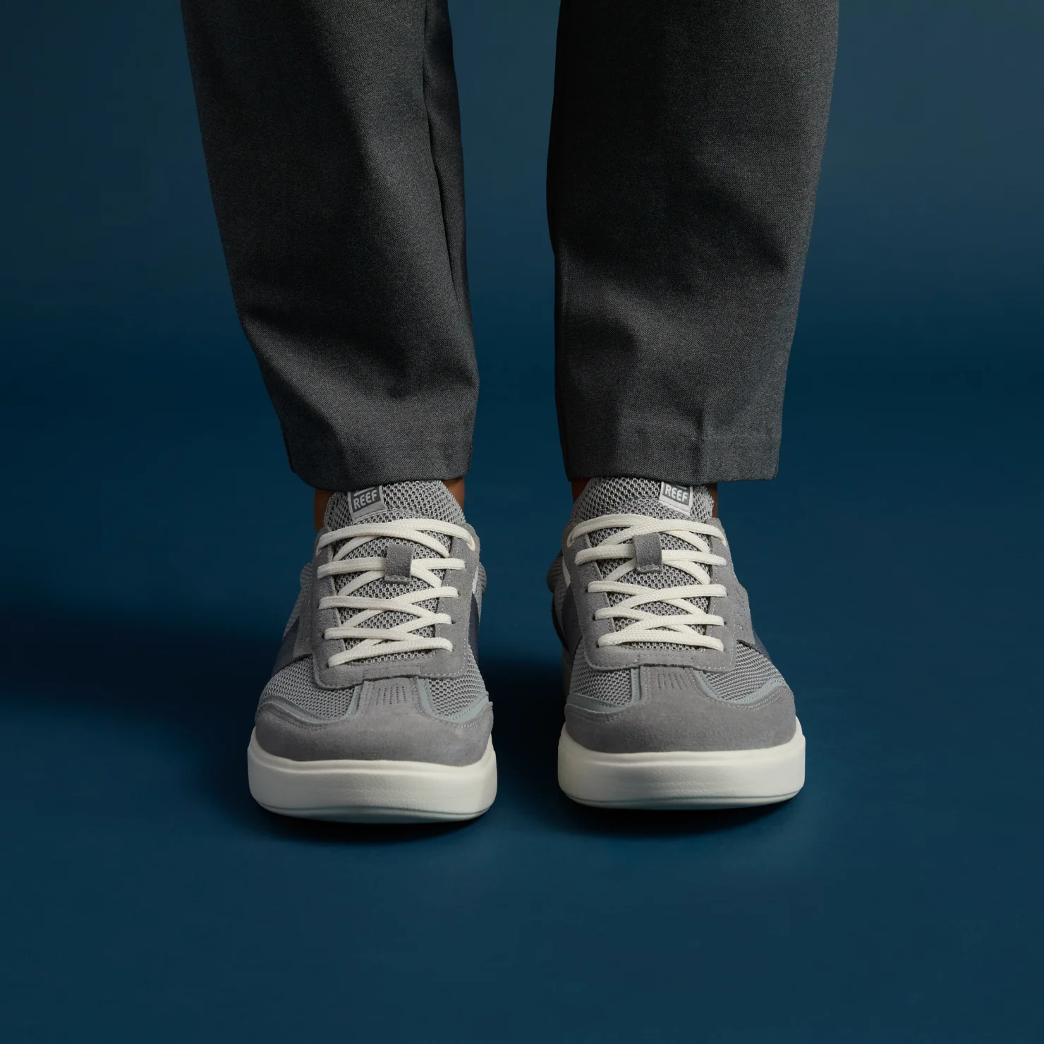 Triton men's grey sneakers facing forward, showing cushioned, breathable upper with lace closure, beach-inspired comfort design.