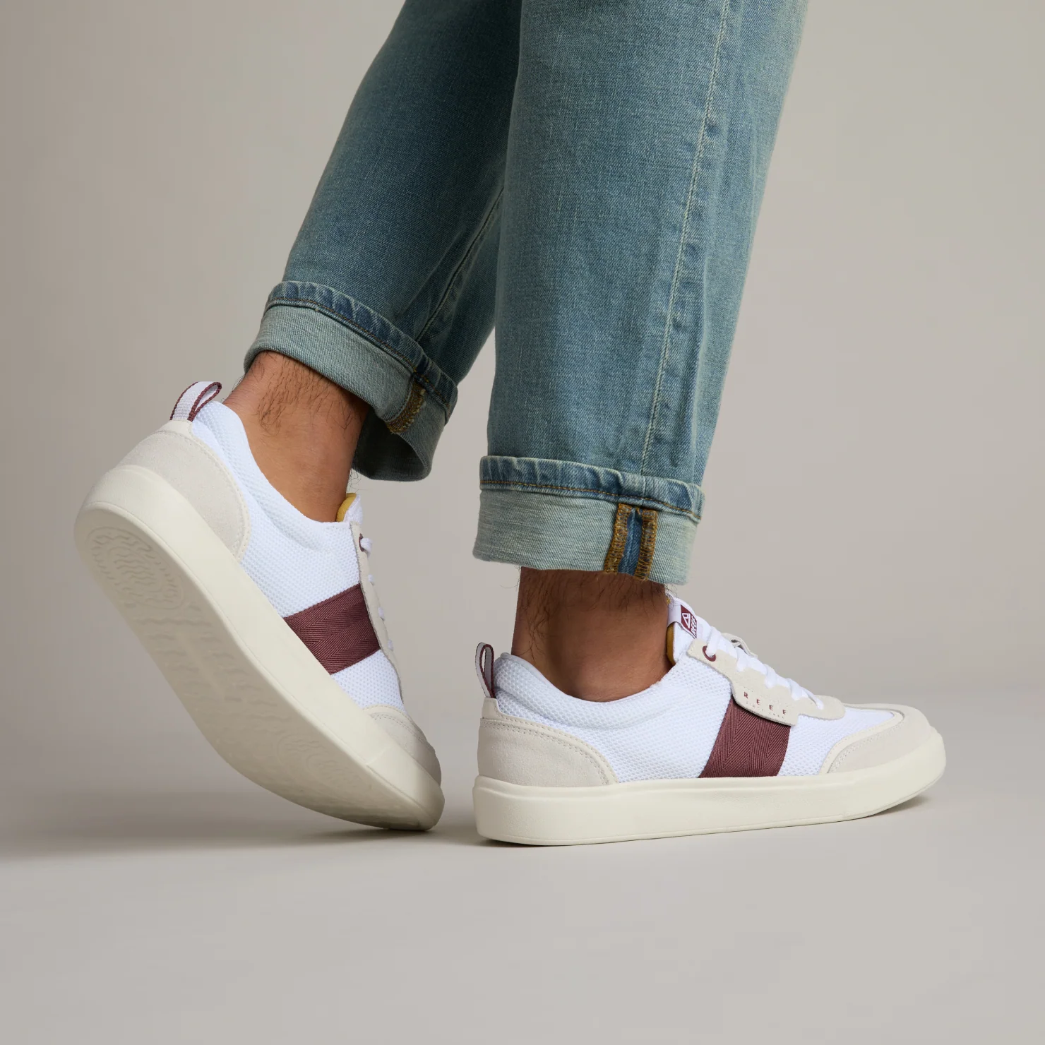 Triton men's white sneaker facing left with brown stripe, showing outer side and sole, lightweight comfort for the beach