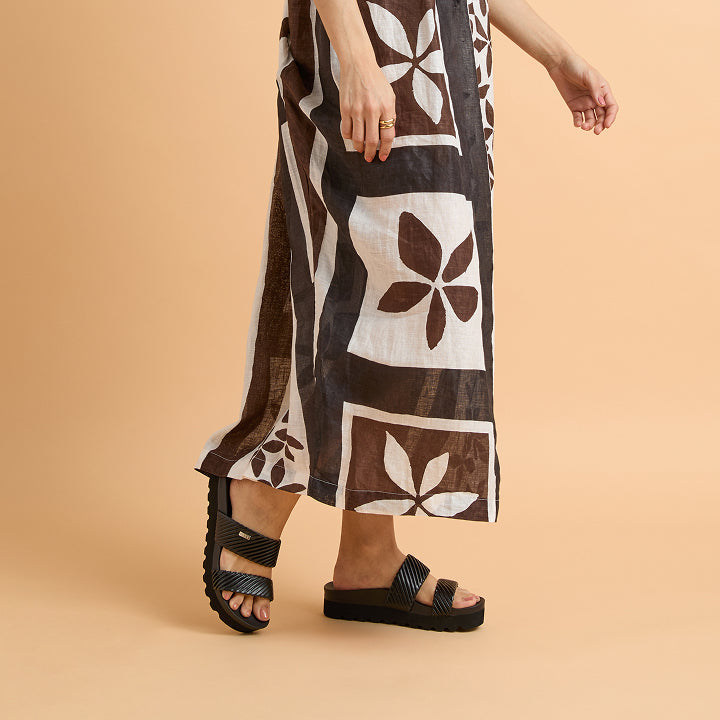 Woman wearing black Cushion Vista Hi sandals facing left in a close-up side view highlighting comfort and arch support.