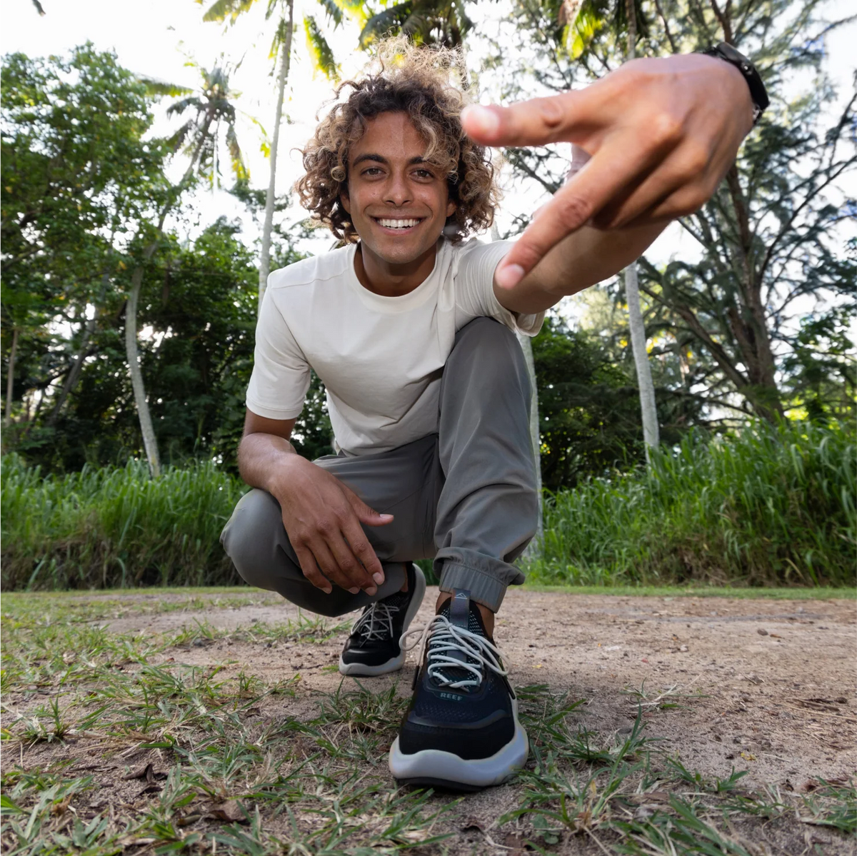 Close-up of Shorebreak TRV sneaker facing forward, worn by man outdoors, showing comfort and surf-inspired design.