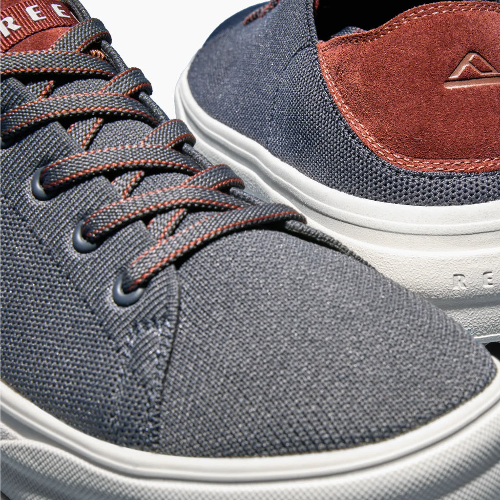 Close-up of the front left and back right of the Atlantic men's shoe in navy with cappuccino accents, designed for comfort.