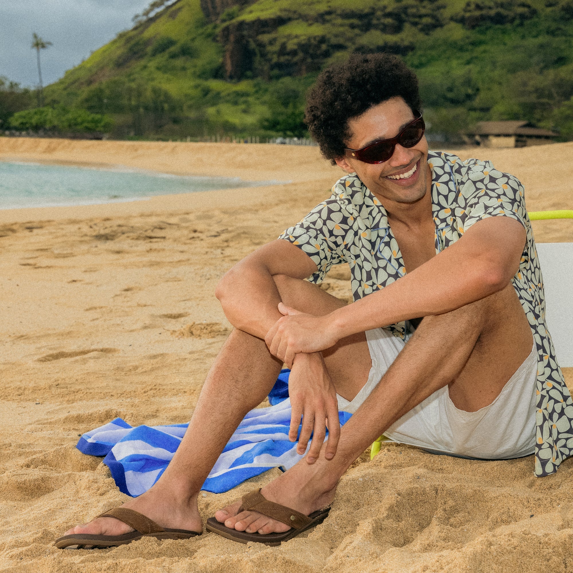 Phantom Lux men's sandal in toffee facing left, featuring cushioned footbed and anatomical arch support on sandy beach.