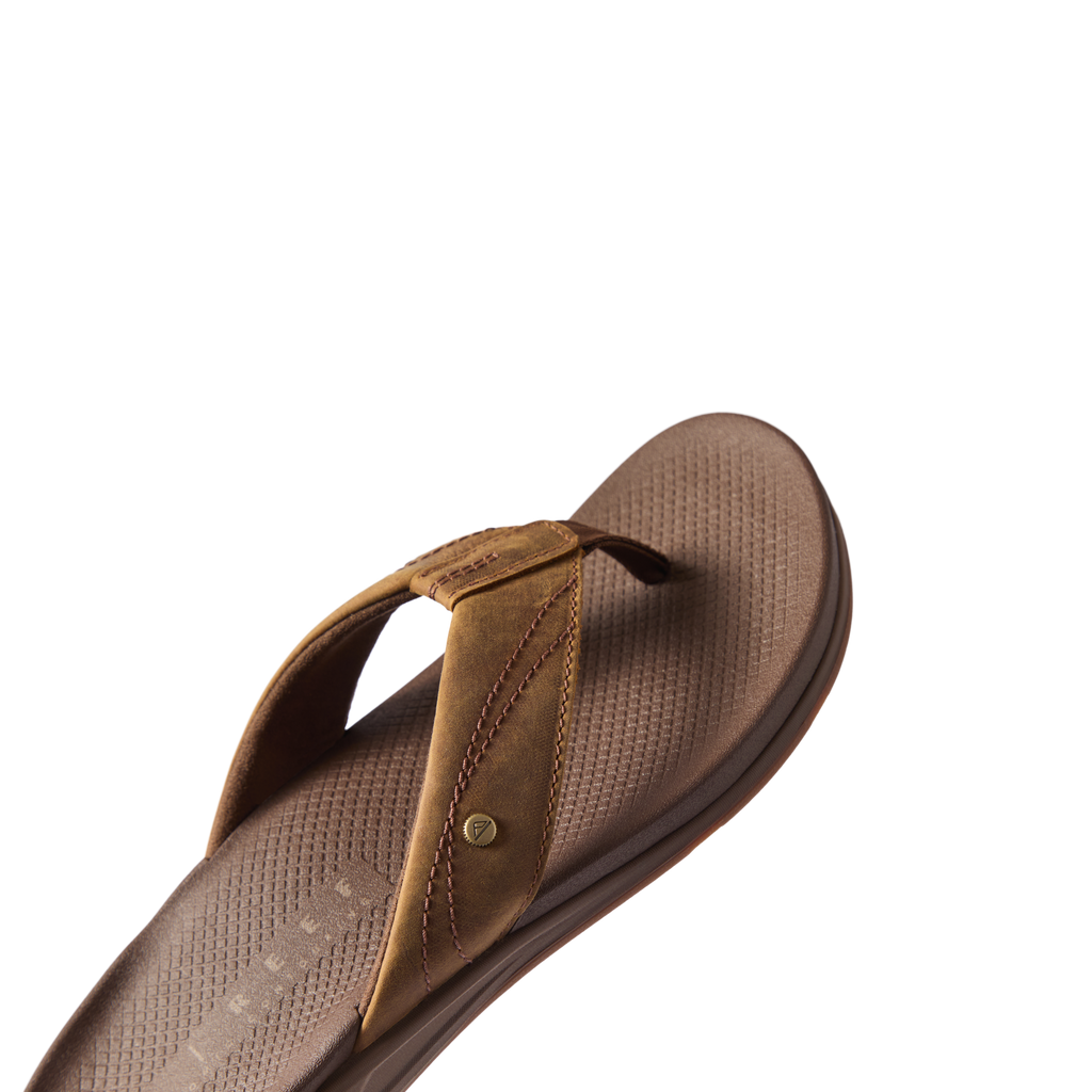 Phantom Lux men's sandal facing right, close-up of cushioned footbed and soft toffee brown straps for beach comfort.