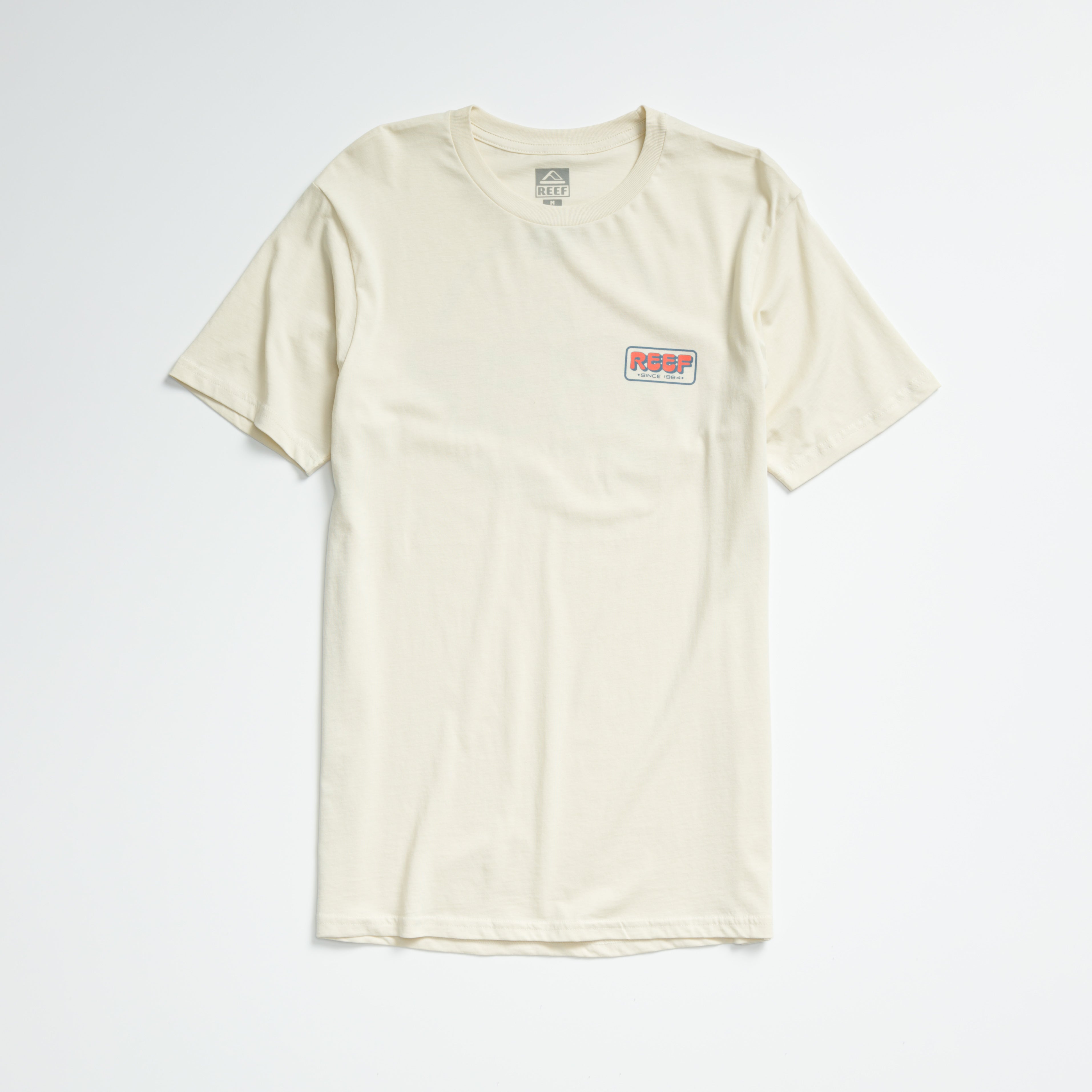 Quinn Tee in almond milk color, laid flat showing front with small REEF logo on chest, lightweight comfort apparel.