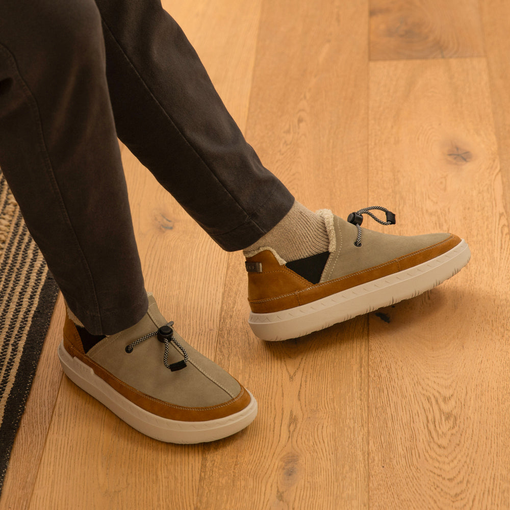 Rambler shoe facing right, close-up of upper and side showing soft-rebound cushioning and arch support in brown tones.
