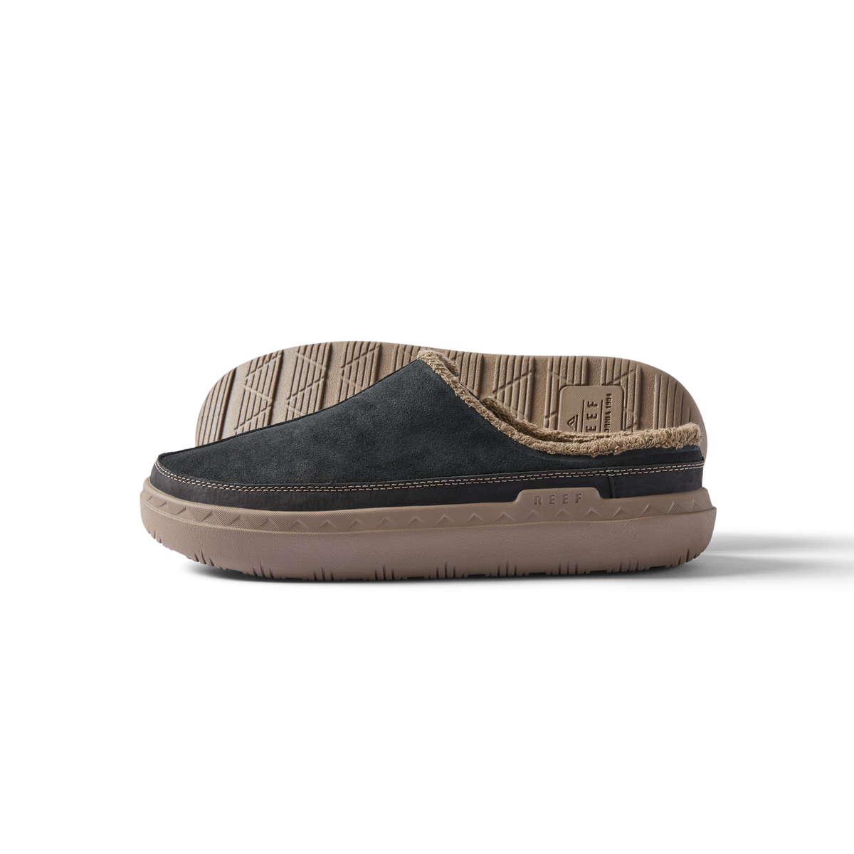 Rambler Mule facing left, showing side profile of black suede men’s slipper with tan cushioned sole and soft lining.