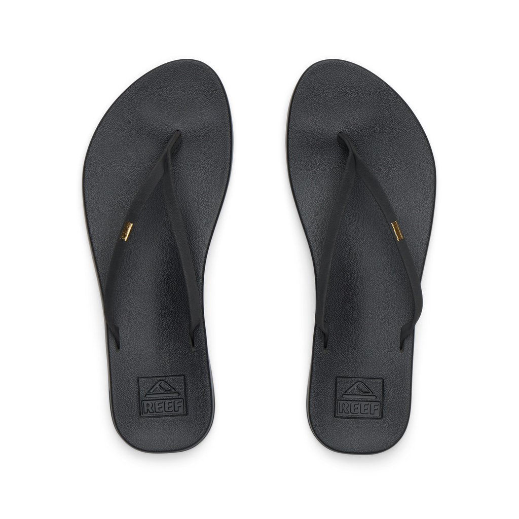 Pair of black Cushion Slim flip flops for women shown from top view, featuring soft-rebound cushioning and anatomical arch support.