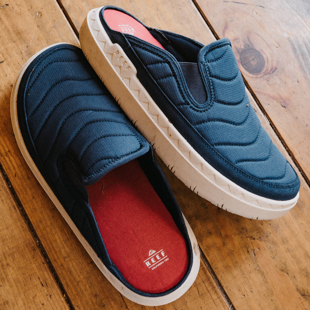 REEF Rambler Kicker slip-on shoes with toes facing right, cushioned footbeds, and lightweight EVA outsoles