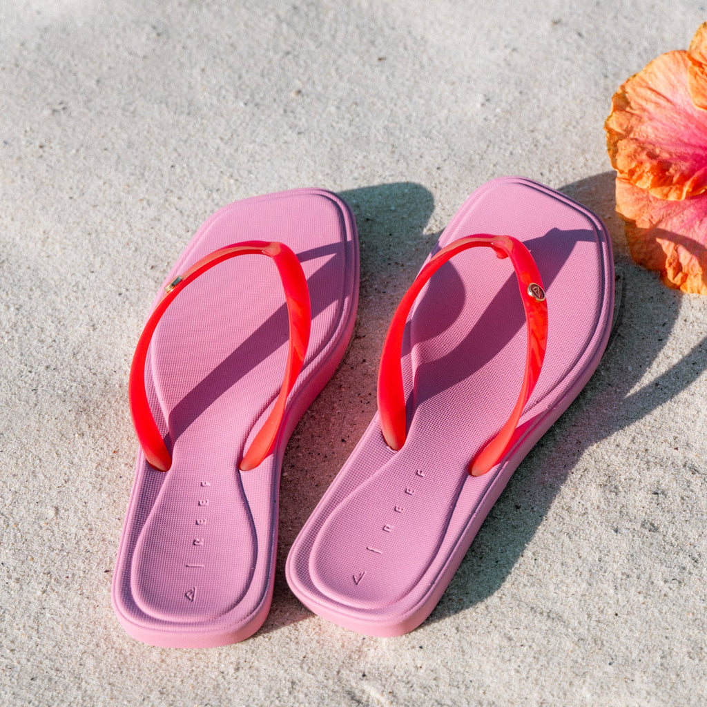 Pink Solaye sandals for women facing upward with red straps and beach-inspired cushioning and arch support