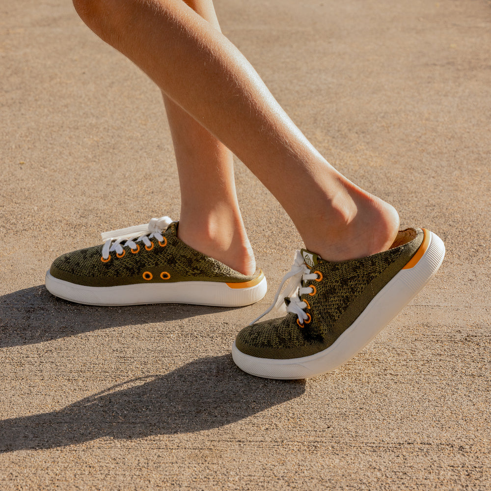 Kids Neptune unisex slip-on sneaker facing right, side view, showing soft-rebound cushioning and arch support design.