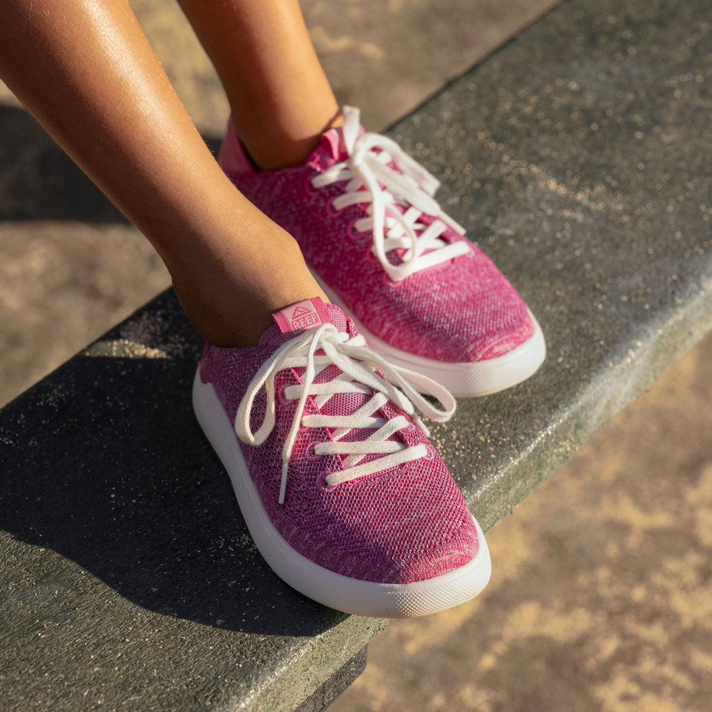 Kids Neptune shoes in pink facing forward, close-up of the upper and laces, designed for comfort and beach lifestyle.