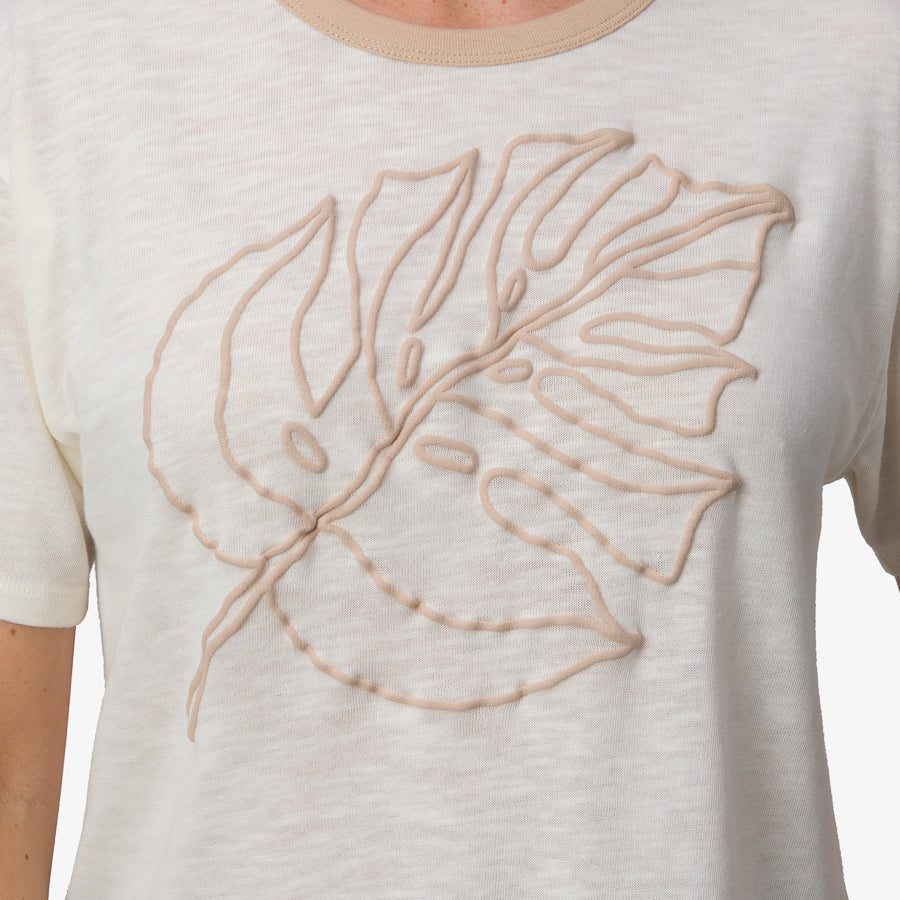 Ringer Tee close-up showing soft marshmallow fabric with beige leaf embroidery and beige neckline trim for women’s comfort apparel.