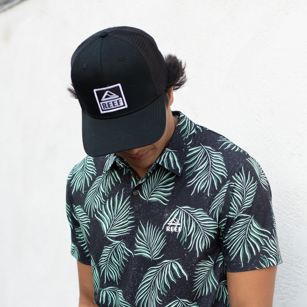 Man wearing a black Townsend Hat facing downward, highlighting comfort and surf-inspired beach apparel style.