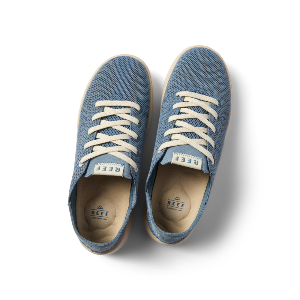 Neptune men's shoes facing up, surf-inspired with anatomical arch support, soft cushioning, and breathable blue mesh upper.