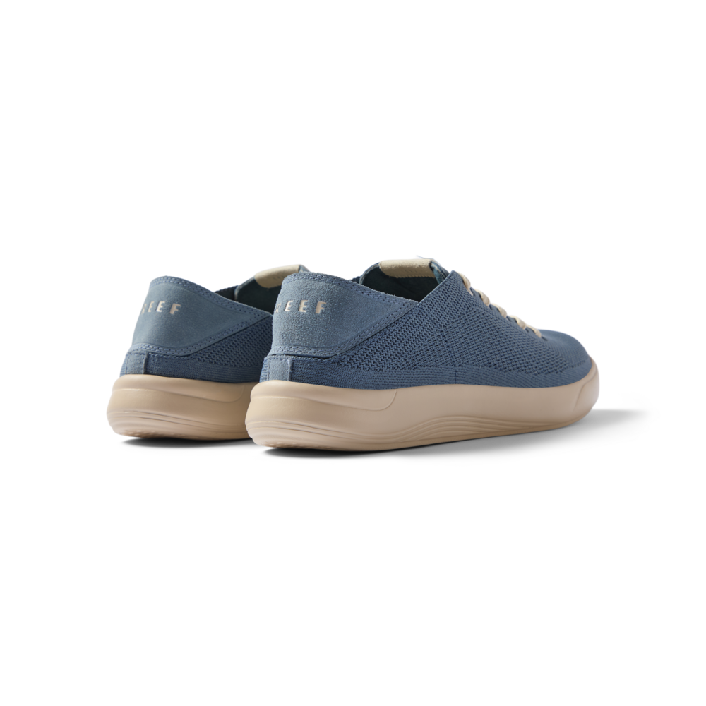 Neptune men’s shoes in true blue facing left, showing the heel and back with anatomical arch support and cushioned sole.