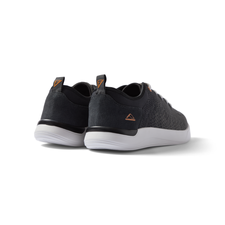 Neso men's black sneakers facing backward, showing heel with anatomical arch support and soft cushioning.