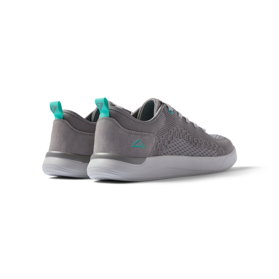Neso men's grey sneakers facing away, showing heel and soft-rebound cushioning for beach-inspired all-day comfort.