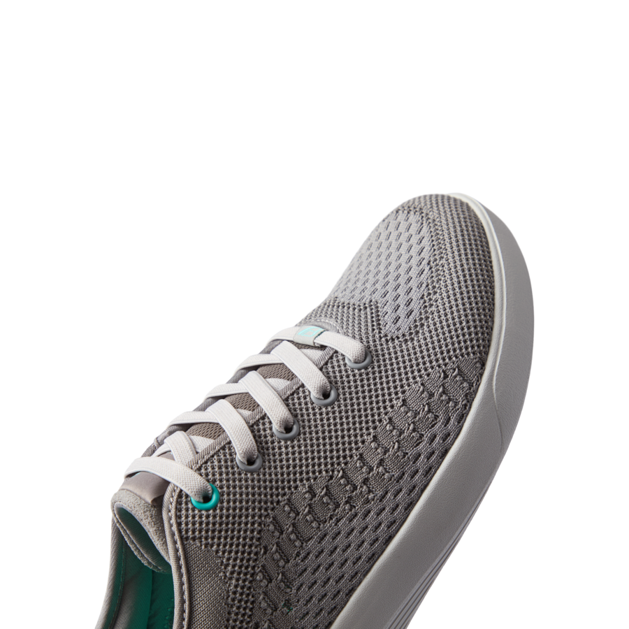Neso gray men's sneaker facing right, close-up on front and side, featuring breathable mesh and cushioned sole for beach comfort.