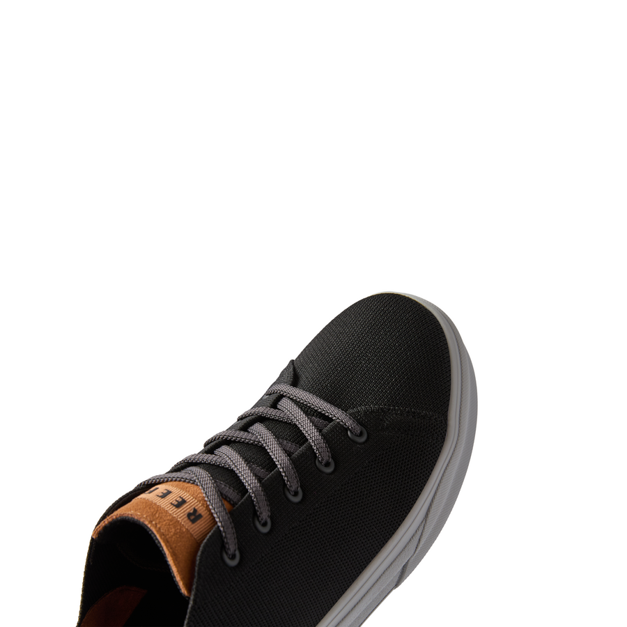 Atlantic men's black and tan sneaker facing right, close-up of toe and lacing, surf-inspired comfort design.