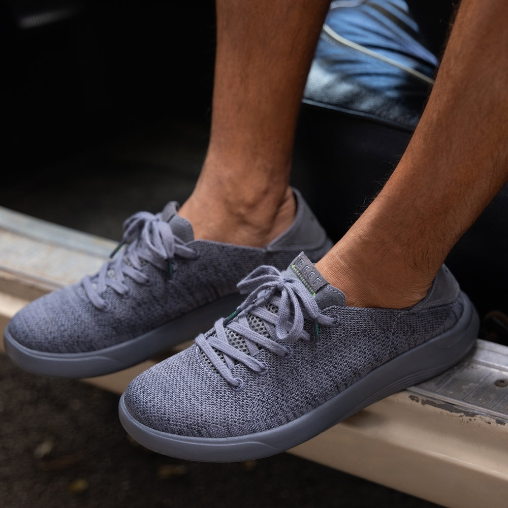 Neptune men's grey slip-on sneaker facing left, showing side and top with soft-rebound cushioning and arch support.