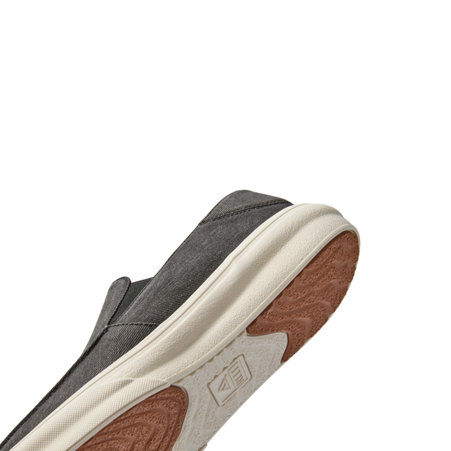 Pacific men's shoe angled to show black upper and textured sole with anatomical arch support for beach comfort