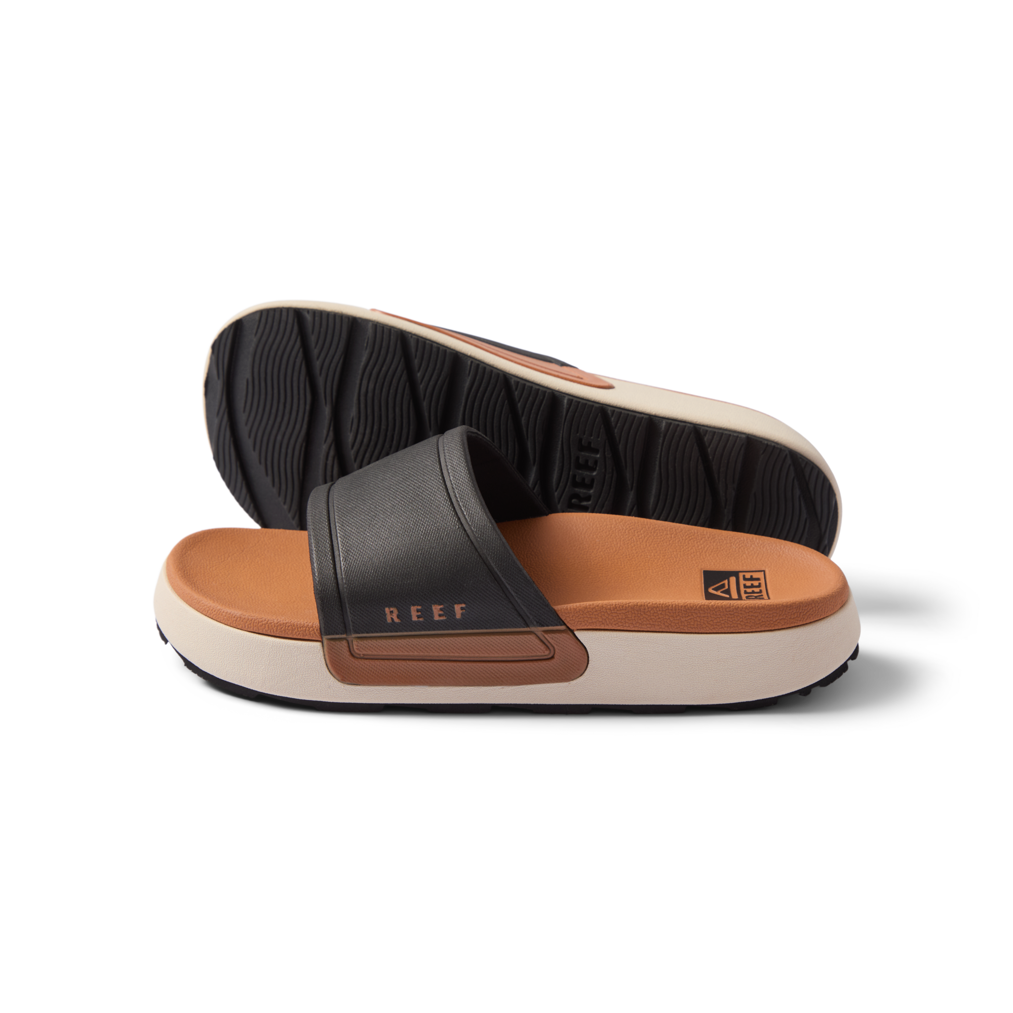 Sydnee Cutback Low women's black and tan slide sandals side view showing soft-rebound cushioned footbed and textured outsole