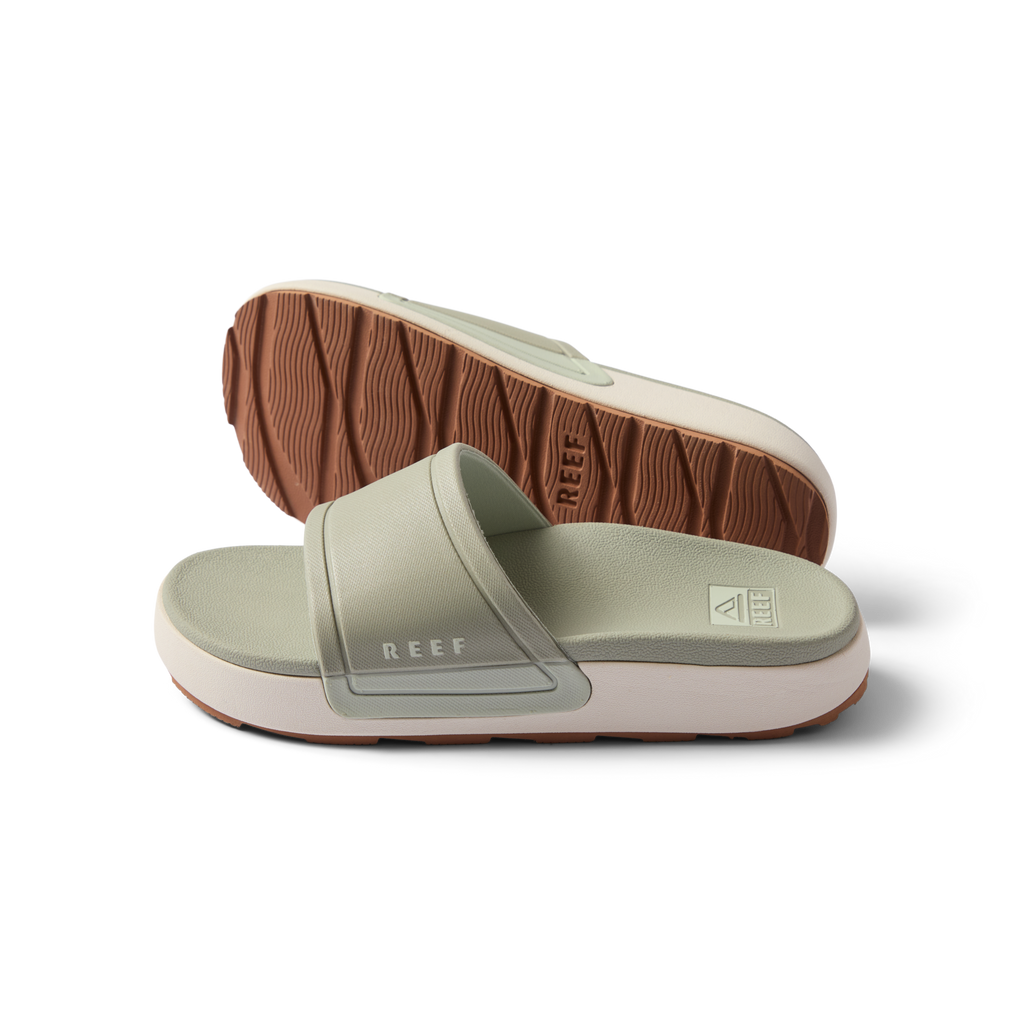 Pair of women's Sydnee Cutback Low slides in sage facing right, showing top and sole with textured brown outsole.