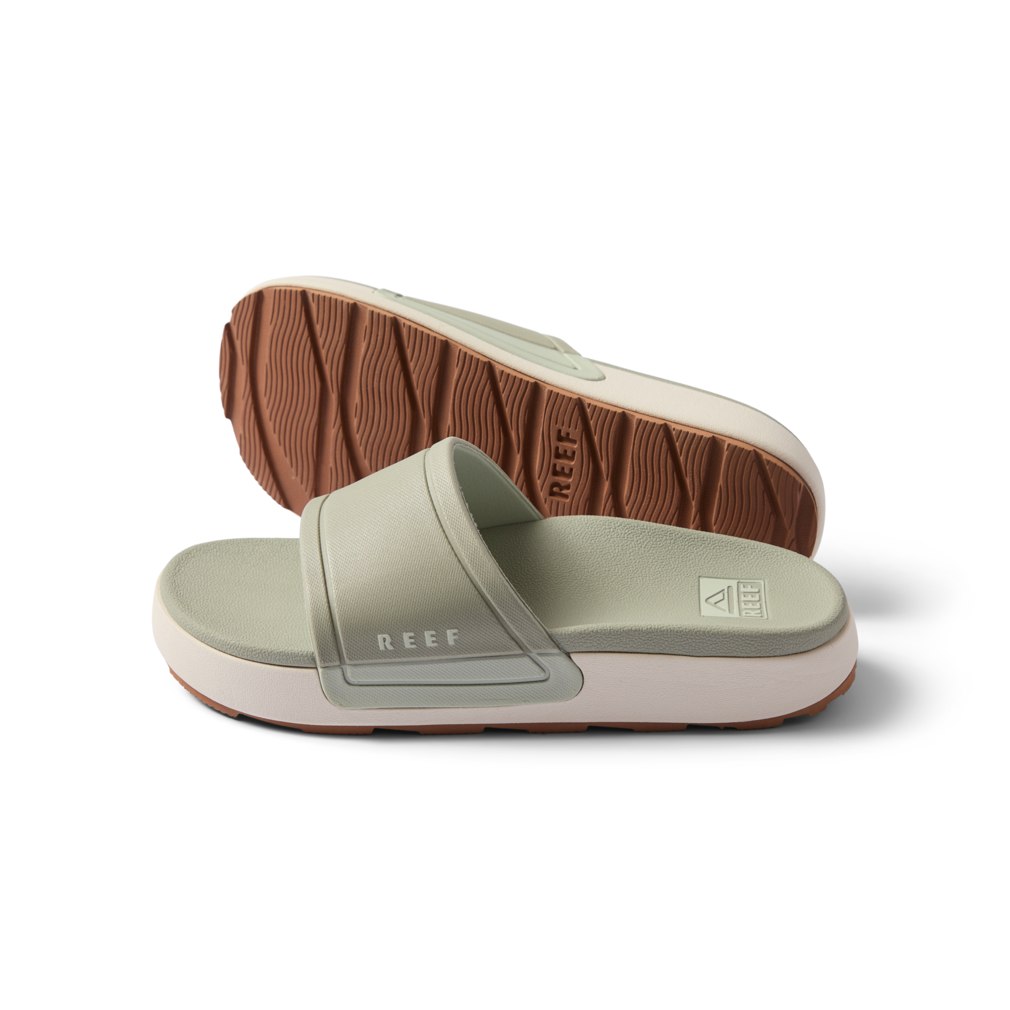 Pair of women's Sydnee Cutback Low slides in sage facing right, showing top and sole with textured brown outsole.