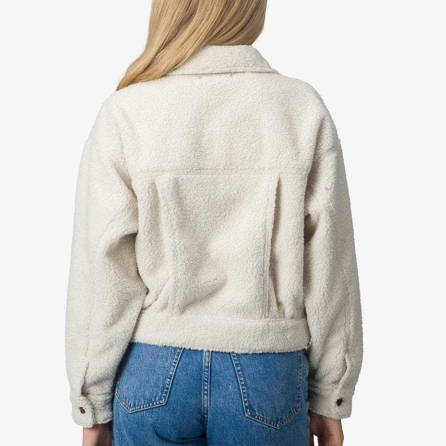 Woman wearing a cream Sammie Sherpa Jacket showing the back, highlighting soft, comfort-focused apparel design.